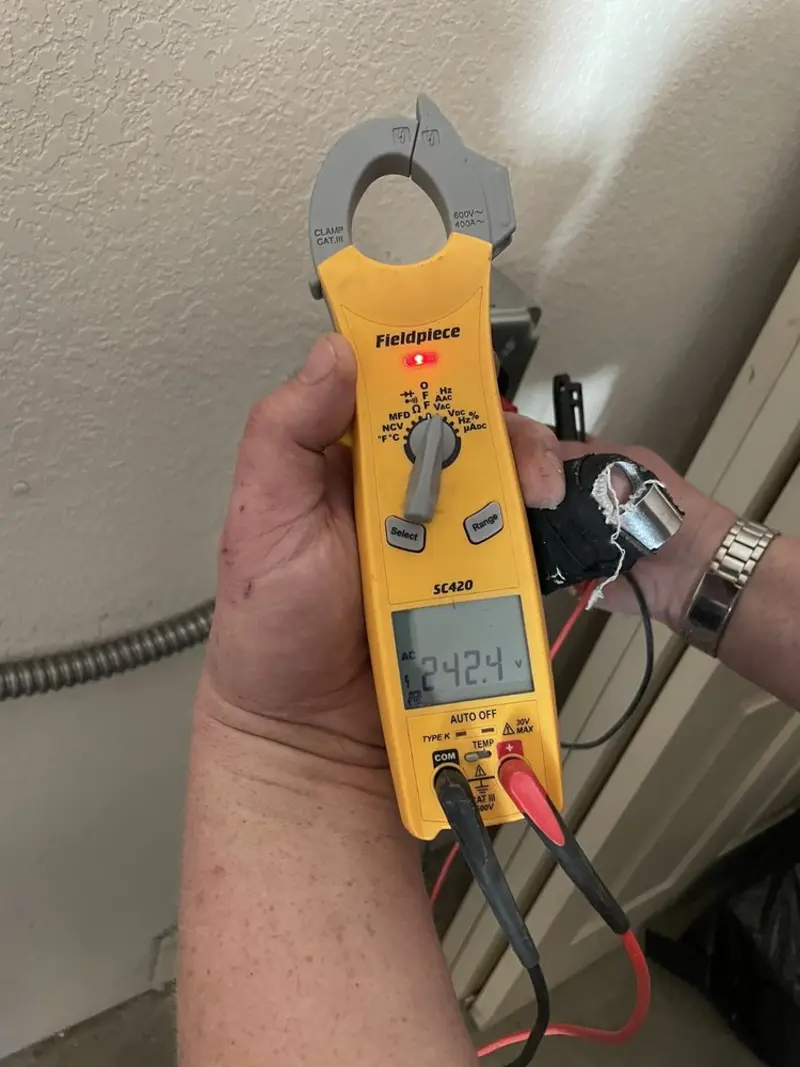 Voltage testing with clamp meter during Whole House Surge Protector in Mayfield Heights